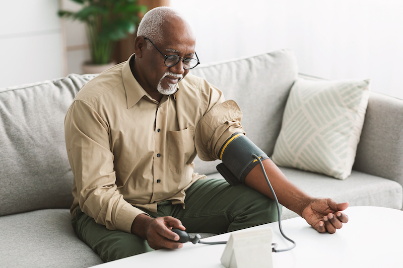 older man with blood pressure gauge