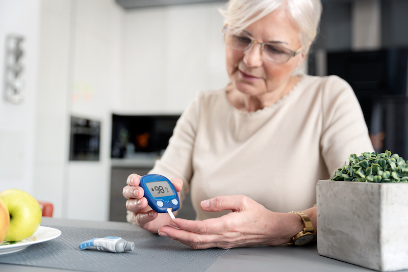older women testing blood sugar
